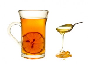 A cup of tea with lemon on a white background.