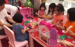 Girls are playing with their Barbie dolls