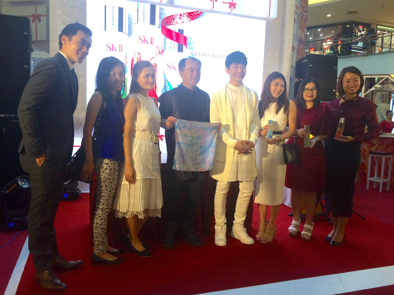 The management of SK-II taking group photo with the special guests, Nicholas Teo and the Japanese Suminagashi master at the launch