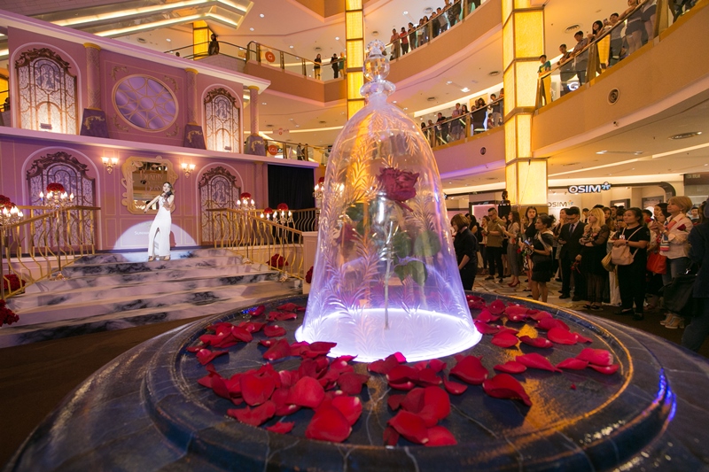 Marvel at the exact replica of the Beast’s enchanted red rose glistening in a bell jar at the center of the concourse.