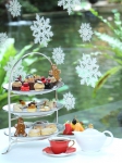 Enjoy Festive Afternoon Tea with a water fountain and lush greenery view