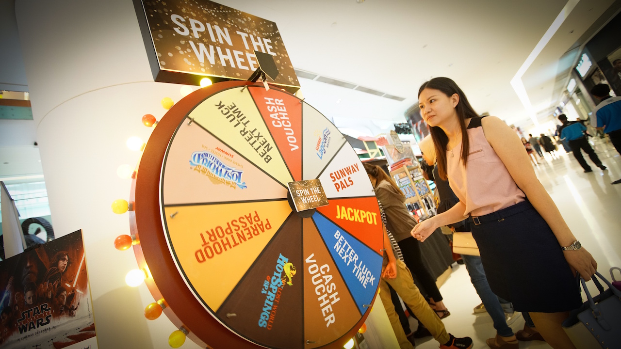 Shoppers trying their luck on Christmas Magical Wheel to win attractive prizes.