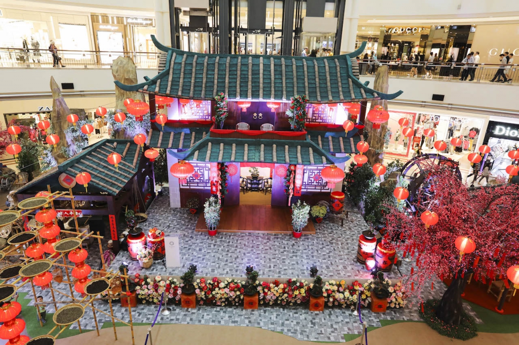 Double storey traditional house surrounded with water mill, wishing trees, tea props and red lanterns.