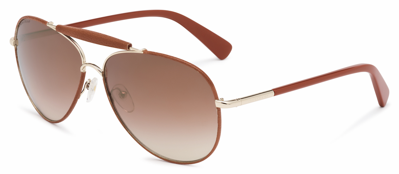 LO100SL This timeless aviator has a metal frame decorated with a leather application on the top bridge bar and around the lens profiles - a bold detail available in the colors of the accessory palette. The lower bridge bar features the same finish as the monoblock hinges, while the temples are defined by contrasting color acetate sections. A laser-engraved Longchamp logo on both sides and the Longchamp horse emblem on the temple tips complete the design. Available in Gold Bourbon, Gold/Dark Brown, Gold/Blue, Rose Gold/Nude and Rose Gold/Burgundy. RRP : RM950