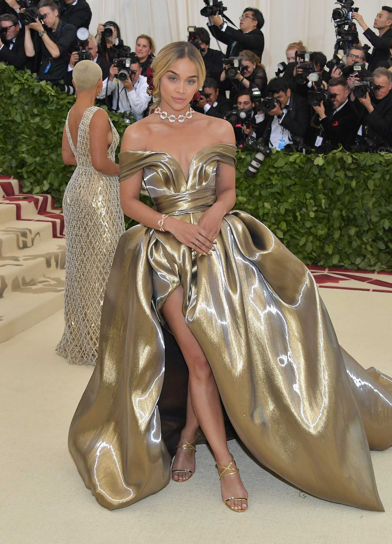 Model and actress Jasmine Sanders wore a voluminous gown of gold metal lamé. The gown was softly draped off the shoulder, then held by an elegant slim waist. The dress then released into a dramatic full silhouette, a high slit revealing Jasmine’s legs to emphasise the modern lightness. (Photo by Neilson Barnard/Getty Images)