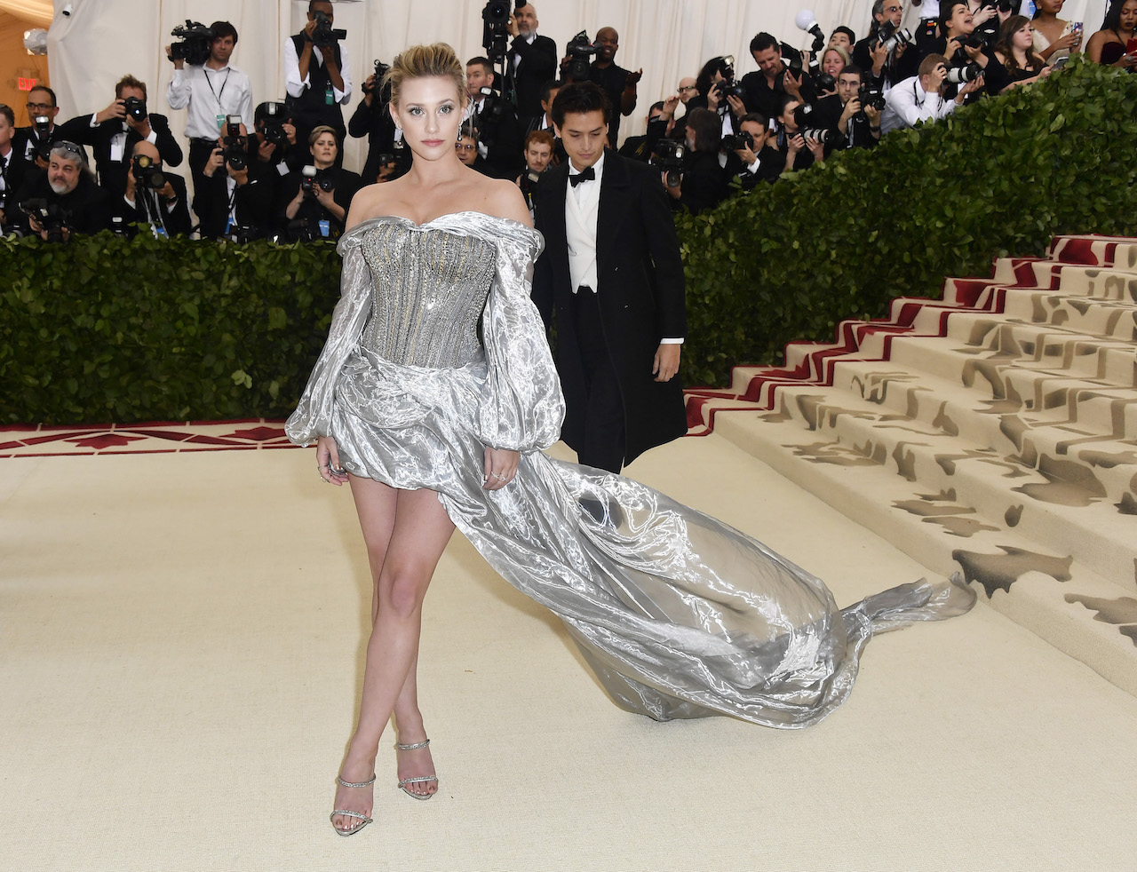 Actress Lili Reinhart wore a silver dress inspired by armour. A cloud-like drape of silver lamé organza was held by a silver corset, creating a dramatic contrast between control and flow. The corset was decorated with chunky metal chains in antique silver, while silver lame organza was draped first as a mini-skirt, before billowing into a long train. (Photo by Frazer Harrison/FilmMagic)