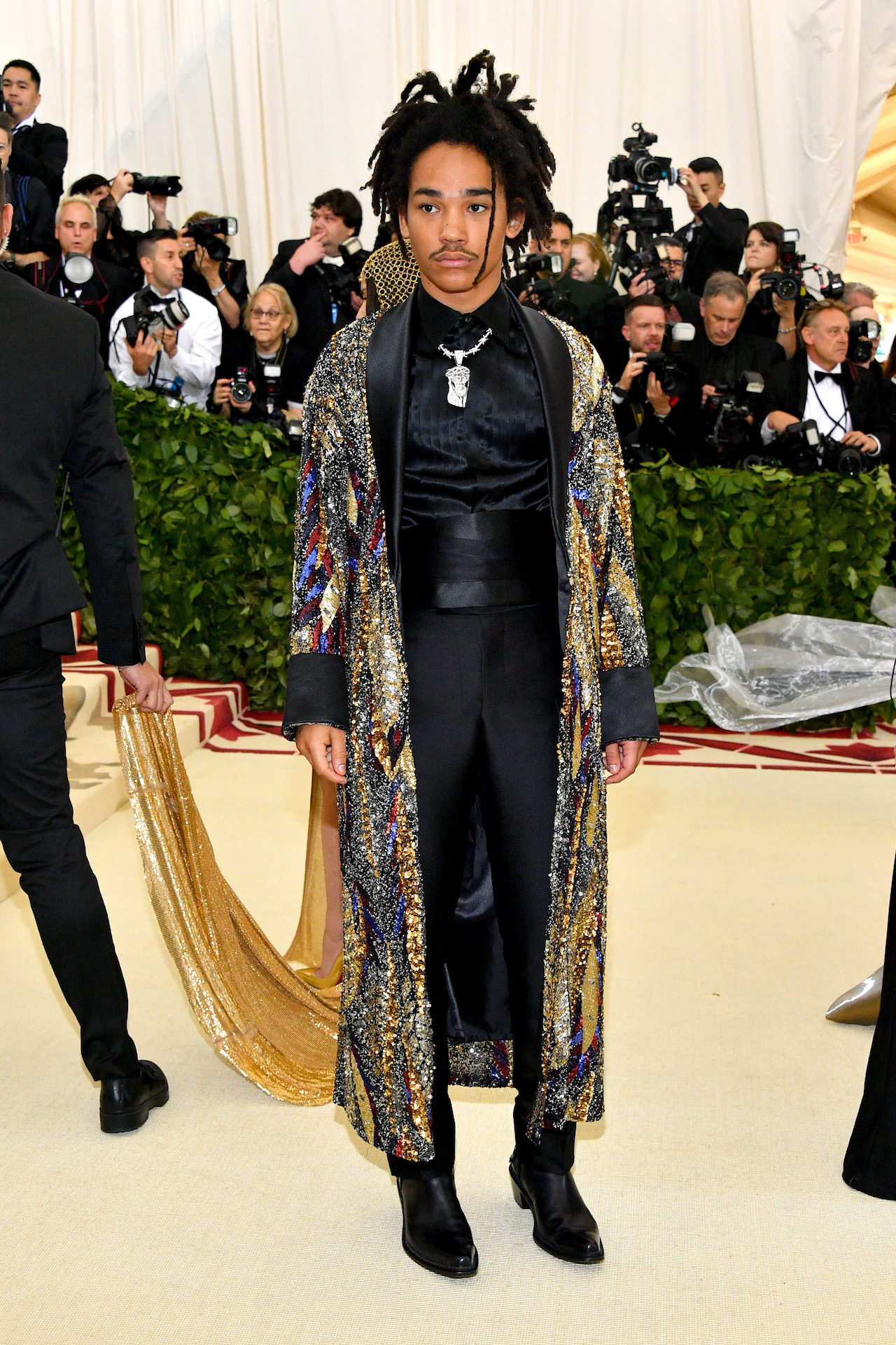 Model and influencer Luka Sabbat wore an extravagant robe entirely hand-embroidered with sequins. The intricate pattern was made from sequins in antique silver, deep red, burgundy, gold and royal blue, while the cuffs, shawl collar and lining were in black silk. Luka also wore tuxedo trousers made from sustainable materials organic silk, TENCEL® and wool. (Photo by Dia Dipasupil/WireImage)