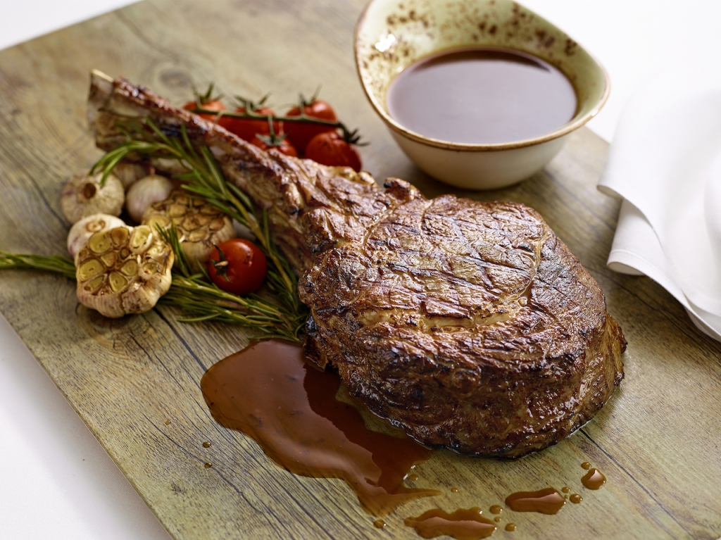Char-grilled Wagyu tomahawk steak with truffle beef sauce by Pierside